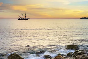 Silhouette of sailing ship at sunset off the coast of Cassis, Bouches-du-Rhone