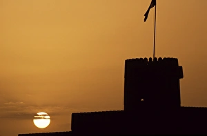 Sharqiya Prints: Silhouette of one of the towers of Ras al Hadd Castle at sunset