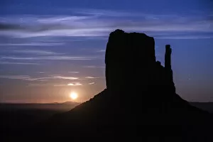 Silhouette of West Mitten Butte at moonrise, Monument Valley, Arizona, USA