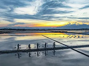 Industry Prints: Silhouettes of workers with salt baskets, Hon Khoi, Khanh Hoa province, Vietnam. (MR)