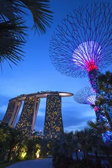 Singapore, Gardens By The Bay, Super Tree Grove and Marina Bay Sands Hotel, dusk