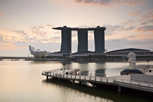 Singapore, Singapore, Marina Bay. The Merlion Statue at dawn, with the Marina Bay Sands in the background