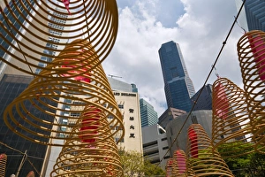 Sky Scraper Gallery: Singapore, Singapore, Raffles Place. Spiral incense coils with city skyline in background at Wak