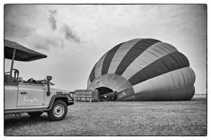 Singita safari car with hot air balloon in black and white, Serengeti Grumeti Reserve Singita safari car with hot air balloon in black and white, Serengeti Grumeti Reserve