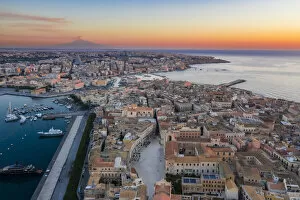 Images Dated 17th September 2020: Siracusa, Sicily. Aerial view of Ortigia island at sunrise with Etna mountain in the