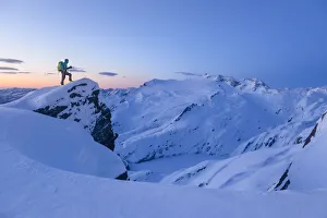 Ski mountaneer near the summit of Lago Peak in Cristallina gruop mountains admiring Ski mountaneer near the summit of Lago Peak in Cristallina gruop mountains admiring