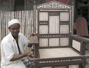 African Man Gallery: A skilled craftsman puts the finishes touches to a