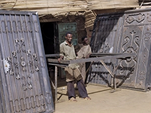 Sudan Gallery: Skilled craftsmen pause beside two pairs of elaborately