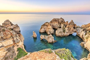 The sky turns pink at dawn on Ponta da Piedade Lagos Algarve Portugal Europe The sky turns pink at dawn on Ponta da Piedade Lagos Algarve Portugal Europe