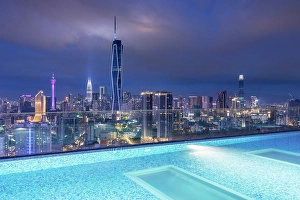 Skyline with Merdeka 118 skyscraper, Menara Kuala Lumpur and Petronas Towers with rooftop pool at dusk, Kuala Lumpur, Selangor, Malaysia