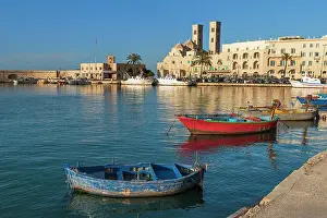 Historical Center Prints: Small fishing boats in the harbour of Molfetta old town with the church in the background