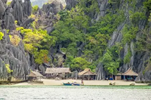 Small native village of thatched huts on the coast of Coron Island, Coron, Palawan