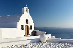 Aegean Prints: Small traditional Greek whitewashed church with caldera view