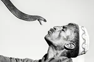 B And W Prints: Snake charmer and his snake, Djemma el Fna, Marrakech, Morocco