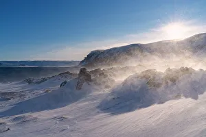Berlevag Prints: Snow blizzard over rocks covered with ice in the arctic landscape