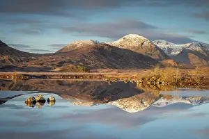 March Prints: Snow capped mountain reflections in Lochan na h-Achlaise on a frosty winter morning in Rannoch Moor