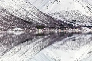 Troms Prints: Snow-covered mountains with a perfect reflection in flat calm waters of Sorfjorden