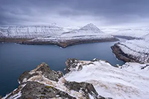 Danish Prints: Snow covered mountains surround Funningsfjordur on the island of Eysturoy in the Faroe Islands
