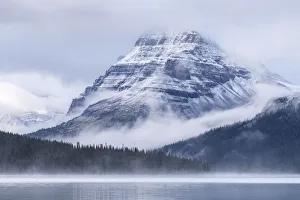 Bow Lake Prints: Snow dusted Bow Peak mountain surrounded by mist, viewed from across Bow Lake, Icefields