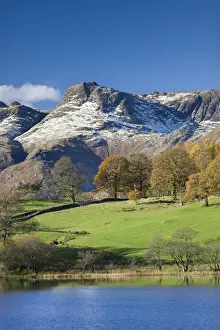 Snow dusted Langdale Pikes viewed from the shores of Loughrigg Tarn, Lake District