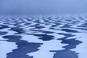 Western Prints: Snow textures shaped by the wind on a frozen lake in the Lofoten islands, Norway