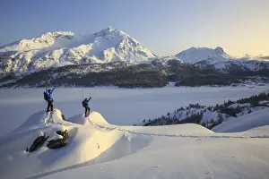 Sport Prints: Snowshoe hikers, Lake Sils and the snow covered Piz de la Margna. Maloja Pass. Engadine