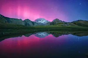 Symmetry Prints: Snowy peak of Monte disgrazia lit by the multicolored sky with Northern Lights