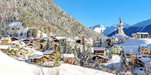Chalet Prints: Snowy woods and mountains framing the alpine village of Alvaneu in winter
