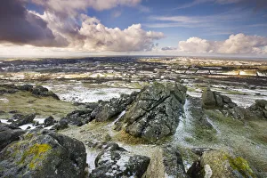 Sourton Tor backed by snow dusted countryside, Dartmoor National Park, Devon, England