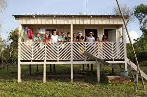 South America, Brazil, Amazonas, Gero Mesquita and a caboclo family stand on the balcony