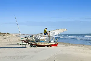 South America, Brazil, Ceara, Fortaleza, a fisherman tending his jangada on the beach