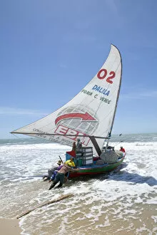 Images Dated 11th October 2012: South America, Brazil, Ceara, Fortaleza, fishermen launching a jangada on the beach