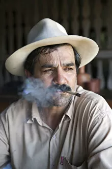 Images Dated 4th December 2012: South America, Brazil, Goias, Pirenopolis, a man smoking a Corn Husk Cigarette in