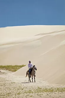 Images Dated 6th September 2012: South America, Brazil, Maranhao, horseman riding through the sand dunes in the pequenos