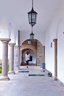 Boutique Prints: South America, Peru, Cusco, a model walks along a cloister corridor in the Orient-Express