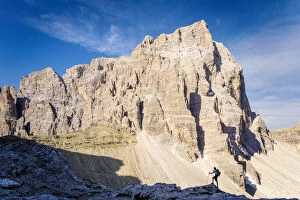 South Tyrol, Sexten, Bolzano. Hiker in silhouette in front of the north east wall