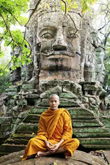 Monks Gallery: Southeast Asia, Cambodia, Siem Reap, Angkor temples, Buddhist monk in saffron robes meditating