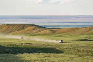 Vehicles Prints: Two soviet vehicles driving on dirt roads. Bayandalai district, South Gobi province