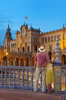 Images Dated 30th September 2011: Spain, Andalucia, Seville, Man and woman infront of Plaza de Espana at dusk (MR)