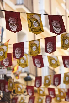 Spain, Aragon Region, Zaragoza Province, Zaragoza, El Tubo entertainment area, flags