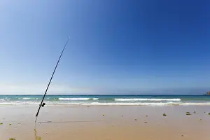 Spain, Bolonia, Tarifa. Lonely and isolated fishing rod on the shore of the beach