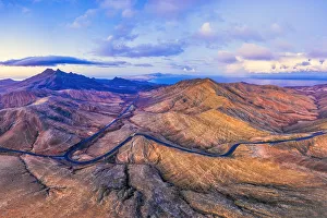 Cardon Mountain Prints: Spain, Canary Islands, Fuerteventura, mountain road crossing the volcanic landscape near