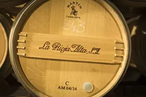 Spain, La Rioja, Haro. Storage barrels at La Rioja Alta, a traditional Rioja winery