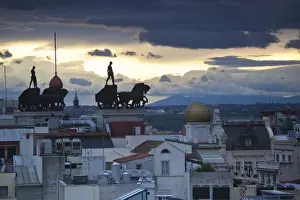 Spain, Madrid, elevated view of figures atop BBVA building, from the Circulo de Bellas