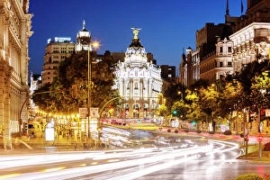 Images Dated 29th July 2014: Spain, Madrid. Street view with Metropolis building and light trails