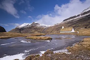 April Prints: Spectacular mountain scenery surrounding Saksuns pretty turf roofed church, Streymoy