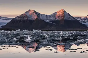 Circle Prints: Spitsbergen, Svalbard, Norway. Mountains reflecting in the fjord at sunrise, with