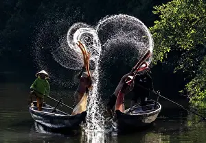 Spray Prints: Spray of backlit water created as local fishermen clean their nets