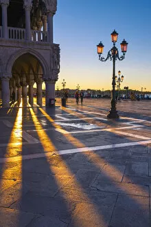 Images Dated 22nd October 2015: St Mark square, Venice, Veneto, Italy. Sun rays at sunrise through the arches of Palazzo