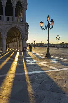 Images Dated 22nd October 2015: St Mark square, Venice, Veneto, Italy. Sun rays at sunrise through the arches of Palazzo